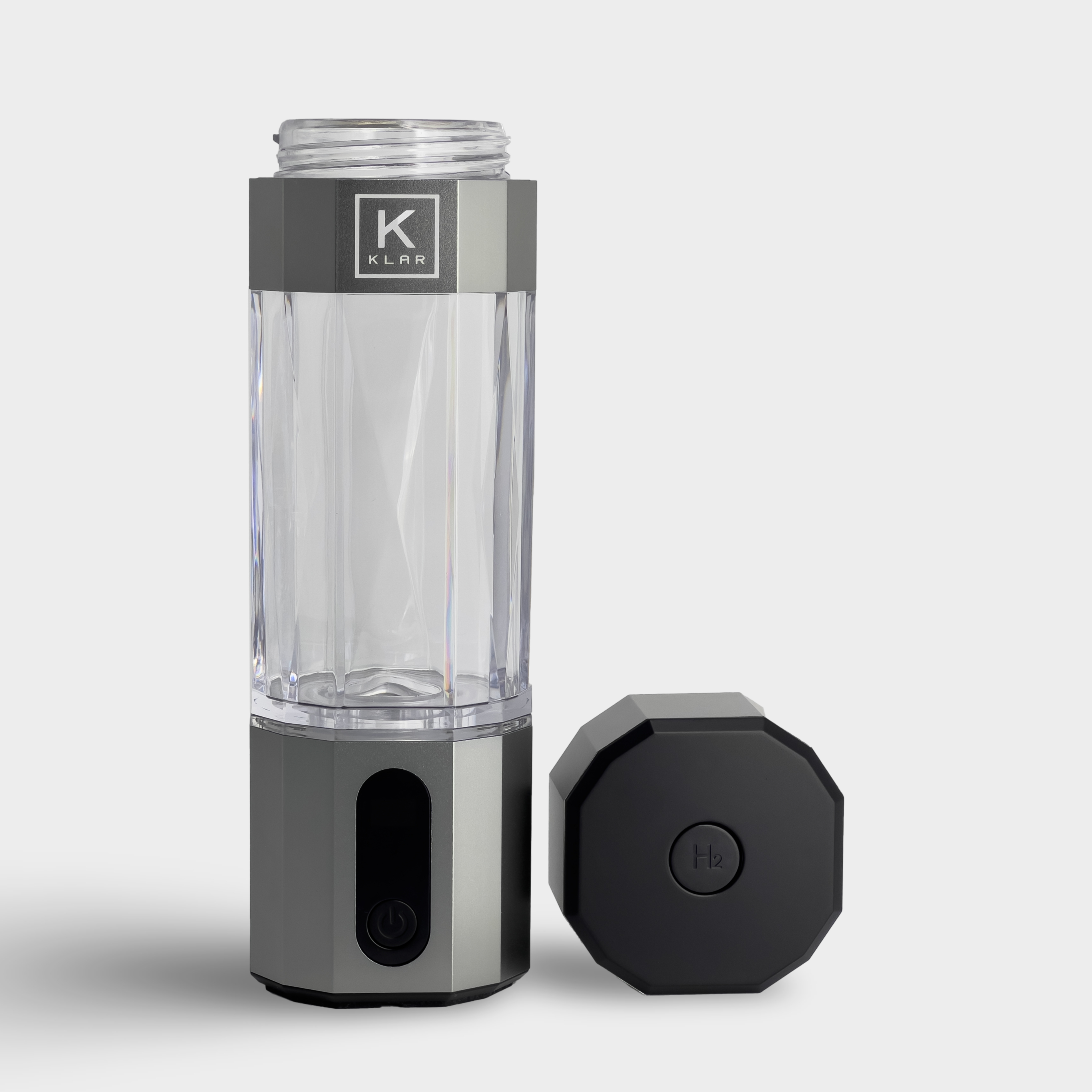 Front view of silver KLAR ELITE hydrogen water bottle with lid, showcasing the pressure release valve on lid.