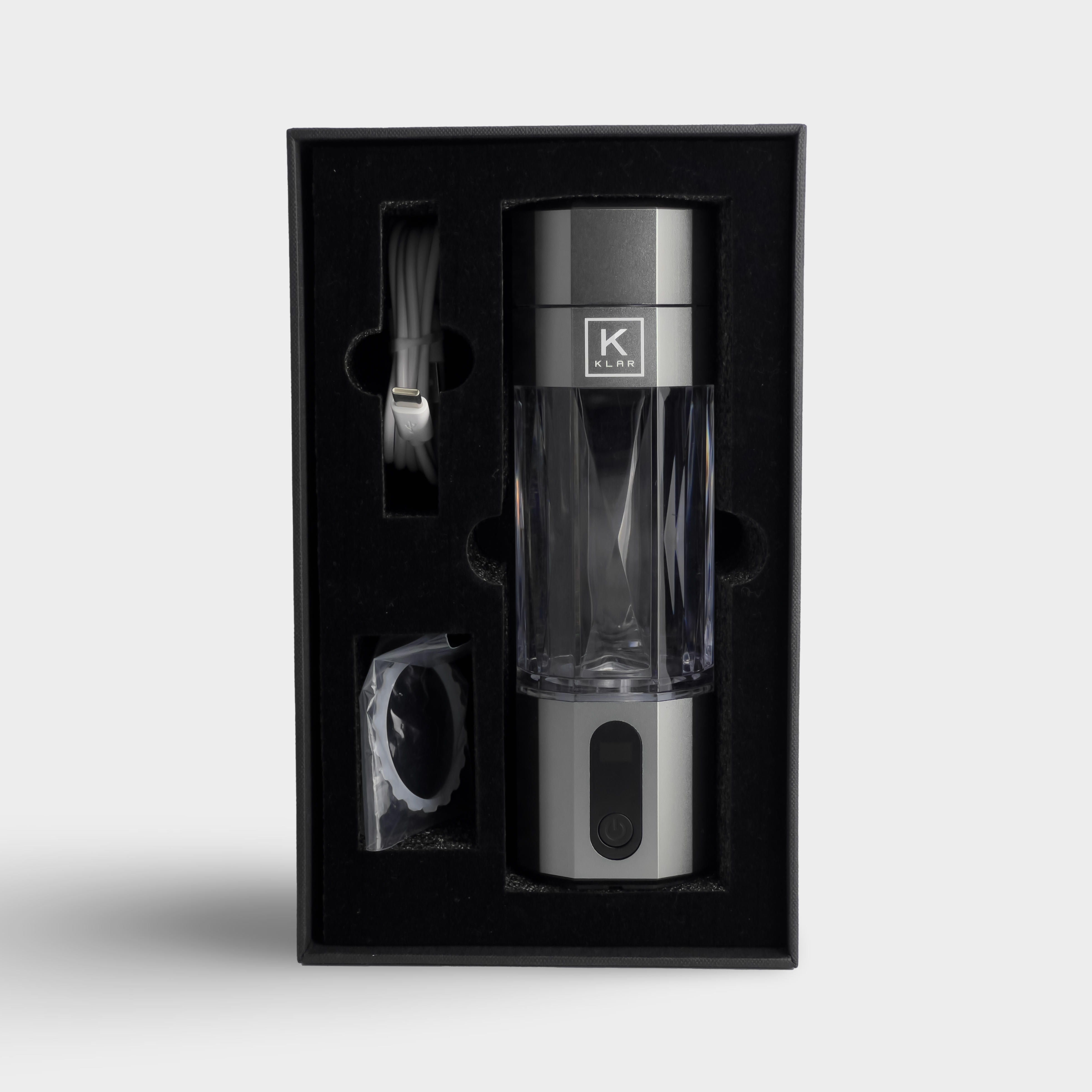 KLAR Elite hydrogen water bottle in packaging with USB-C charging cable and replaceable seal ring.