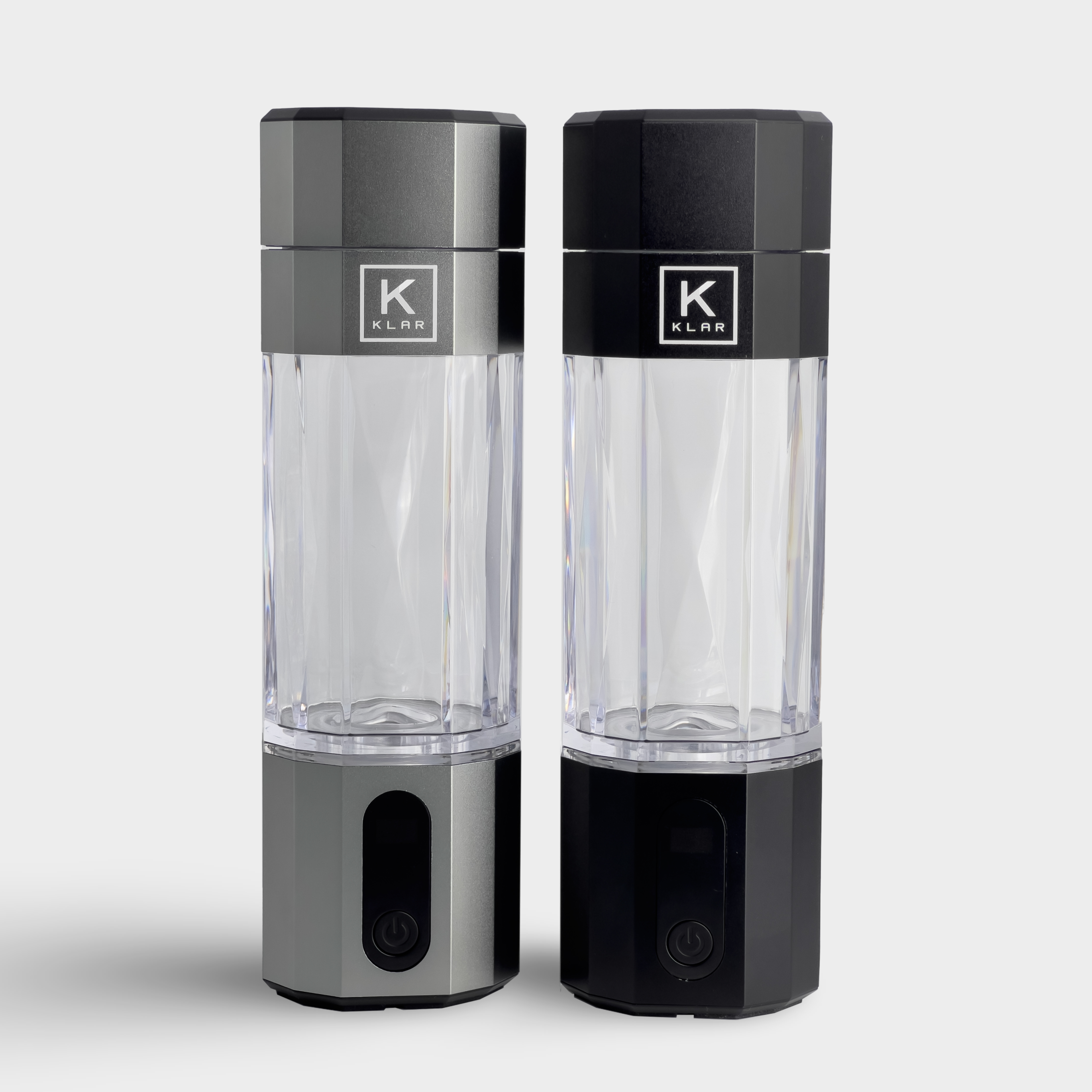 Front view of silver and black KLAR ELITE hydrogen water bottles side by side